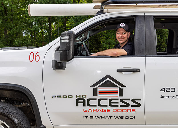 Smiling Access Garage Doors technician in truck