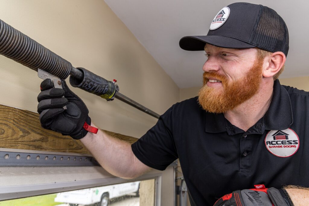 Working on a garage door spring.