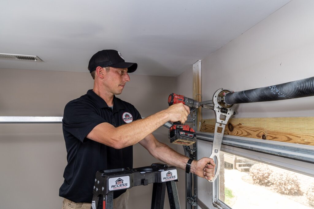 Specialist tightening a garage door spring