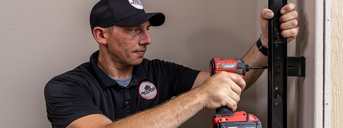garage-door-install Access Garage Doors technician working on a garage door installation