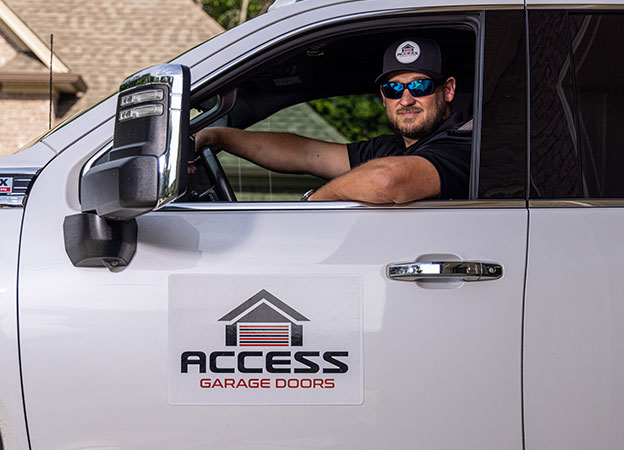 Technician in an Access Garage Door service truck