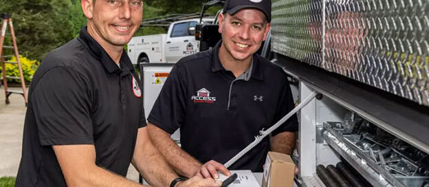 Garage door techs holding tools and materials