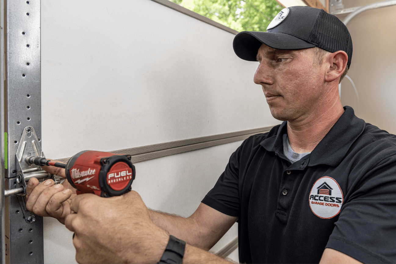 Purvis garage door repair technician with a drill