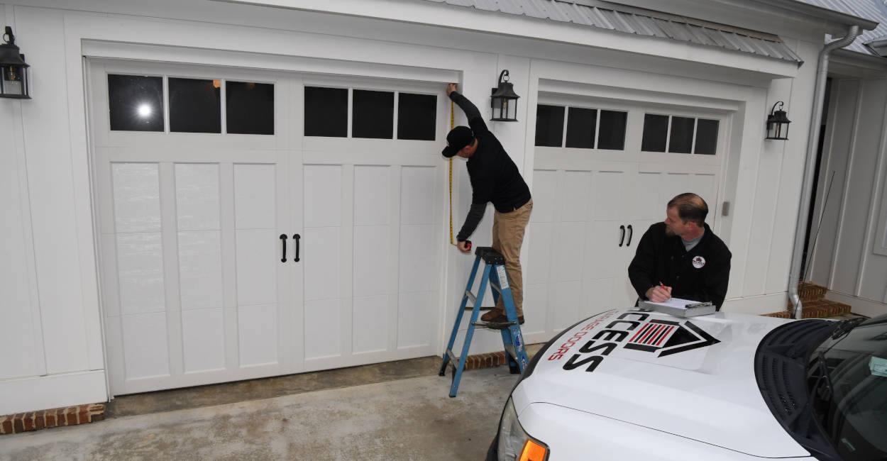 garage-door-estimate New Market, AL techs taking a garage door estimate