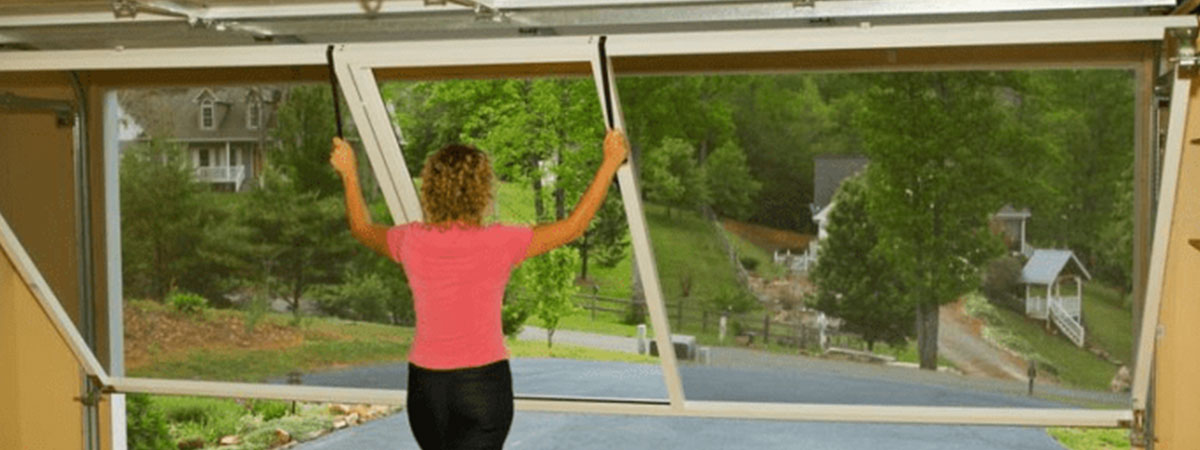 letting-down-screen Woman letting down garage door screen
