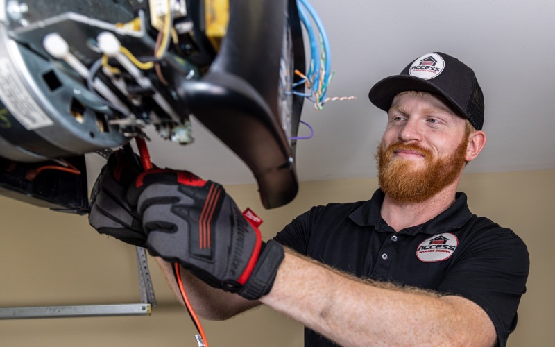 Spring repair on a garage door by a tech in Johnstown, CO