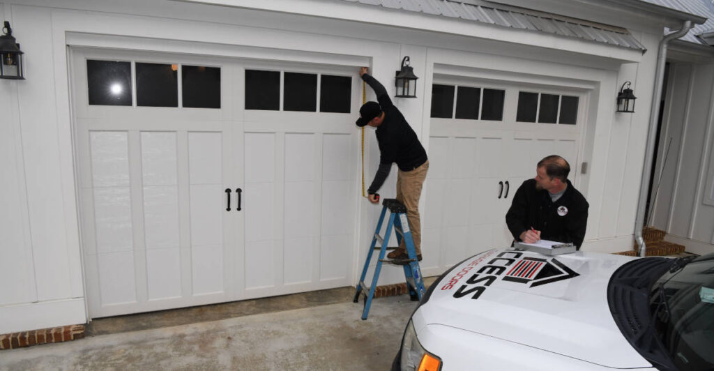 Layton techs taking a garage door estimate