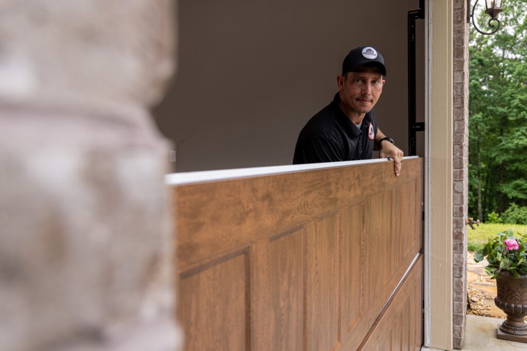 A garage door specialist is lining up a panel on a door in Bountiful