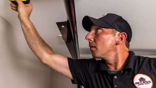 Access Garage Doors employee repairing a garage door