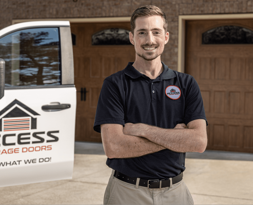 Garage door specialist smiling in front of home