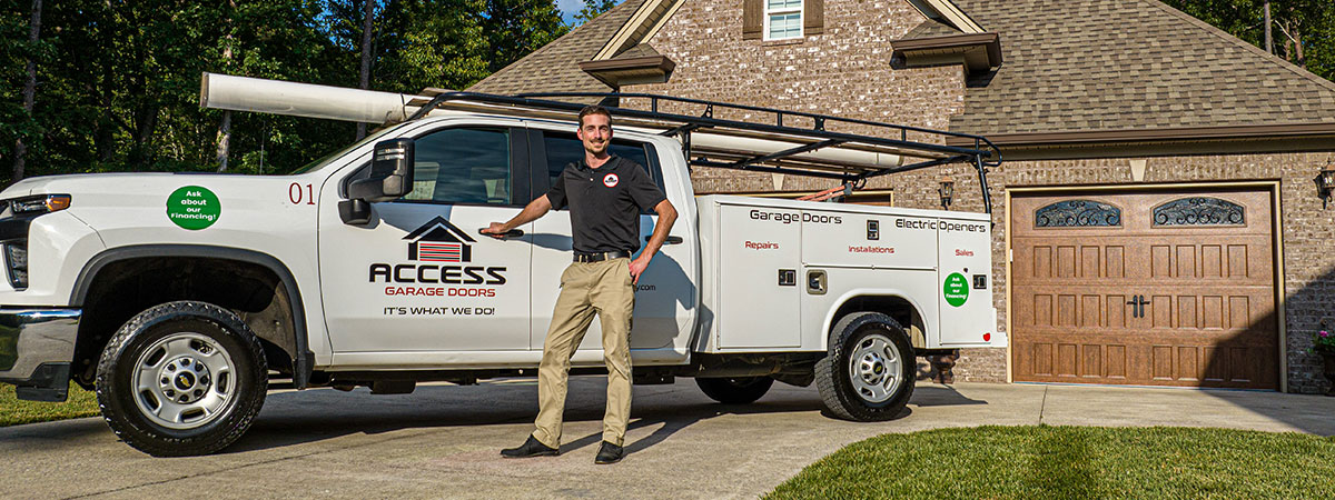 Garage door specialist in front of home garage door