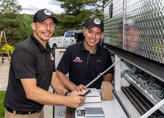 garage-door-techs Garage door techs holding tools and materials